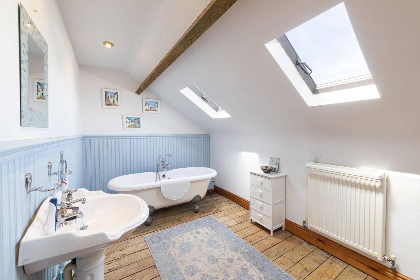 modern bathroom with freestanding bath and blue panelling